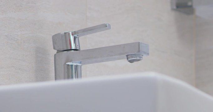 water droplets on tap in batroom leaking