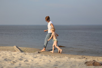 Mom son playing sea beach emotions hands