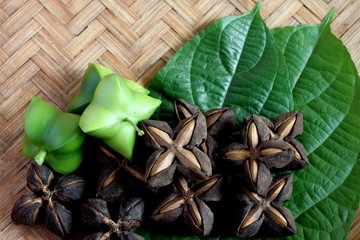 Seeds inca peanut or sacha peanut or sacha inchi or mountain peanut place on the wooden background. 