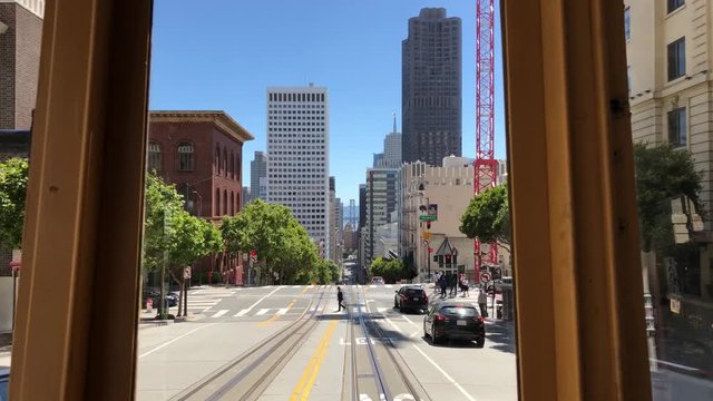 A gimbal shot from the back of a trolly traveling through San Francisco