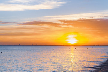 Beautiful summer sunset with clouds over the sea