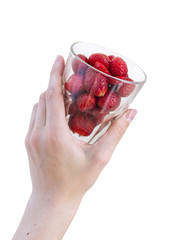 Female hand holding glass beaker with fresh strawberries isolated on white background
