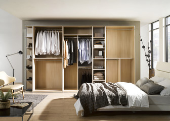 Big wardrobe with different clothes for dressing room. Interior structure of wardrobe body and...