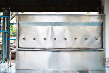 Old water tank made from stainless steel in the school for student