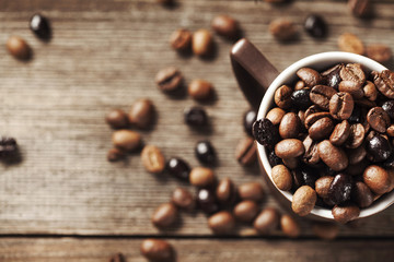 Coffee cup and coffee beans on wooden background