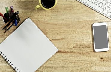 Blank white Paper and smart phone with  black screen and the cup of coffee and office supply for working business communication concept.