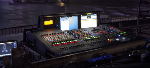 music, technology, people and equipment concept - hands using mixing console in sound recording...
