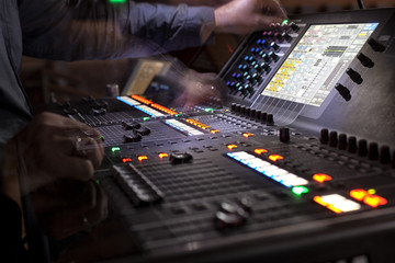 music, technology, people and equipment concept - hands using mixing console in sound recording...