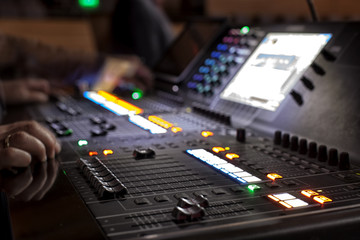 music, technology, people and equipment concept - hands using mixing console in sound recording...