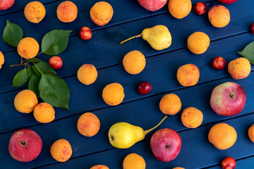 Fresh fruits on blue wooden background. Top view.