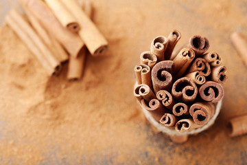 Cinnamon sticks bunch and powder. Aromatic spice. Top view.