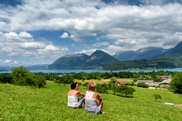 Naklejka na ściany i meble two women looking at Annecy lake in France