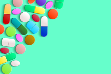 Assorted pills, tablets and capsules in the upper left corner on a light green background, top view. Pharmaceutical medicine concept with copy space.