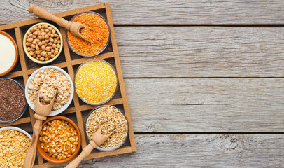 Cereals and legumes assortment on wooden table
