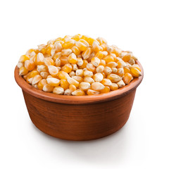 Dry corn in bowl on white background