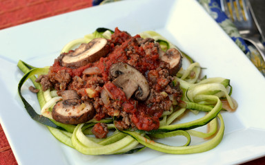 Keto diet meal of spaghetti Bolognese on spiralized zucchini noodles: profile, closeup, selective focus