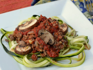 Keto diet meal of spaghetti Bolognese on spiralized zucchini noodles: profile, closeup, selective focus