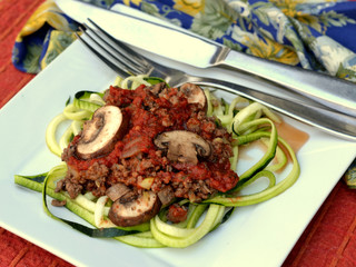 Keto diet meal of spaghetti Bolognese on spiralized zucchini noodles: profile, closeup, selective focus