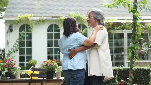 Husband abd wife dance on the front of house