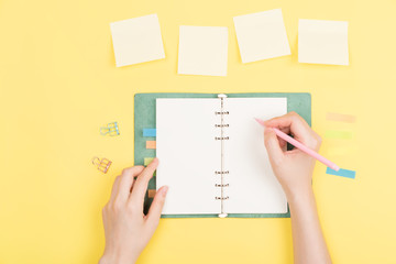 girl's hand writing in notepad