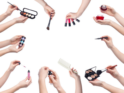 Set of makeup cosmetics in hands on white background