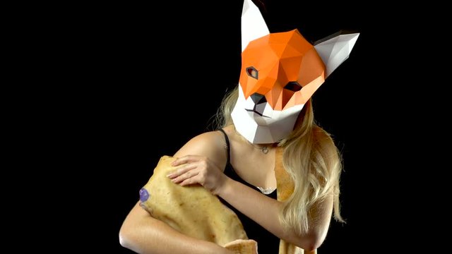 Blonde Girl with Fox Mask paper Using Pig Skin for Covering. Black Background. 4k UHD