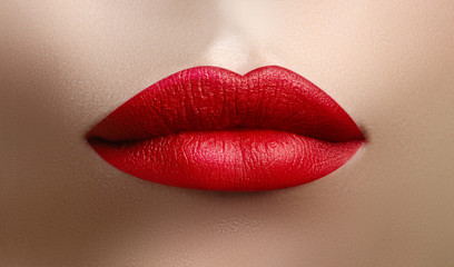 Cosmetics, makeup. Bright lipstick on lips. Closeup of beautiful