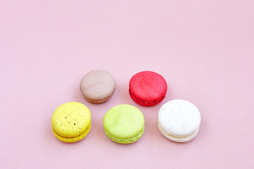 Colorful macaroons or macarons arrange on the lemonade color background with copy space, isolated
