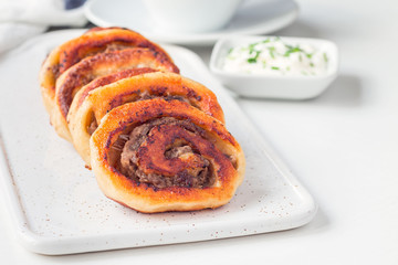 Fried savoury cottage cheese pies with minced meat on white plate, served with yogurt, horizontal, copy space