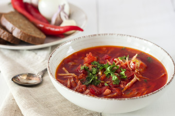 Ukrainian borscht in a plate on a wooden table