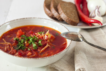 Ukrainian borscht in a plate on a wooden table