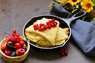 thin pancakes stack in a frying pan, rustic still life