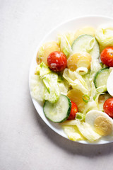 New potato, cherry tomatoes, lettuce, cucumber and egg mayo salad 