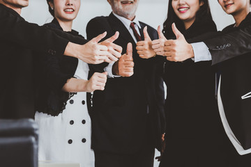 Business team with thumbs up