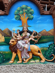  View of Hindu Goddess Durga holding weapons, sitting on lion to kill demons,as per mythology,wall...