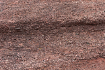 red natural stone background with small rocks