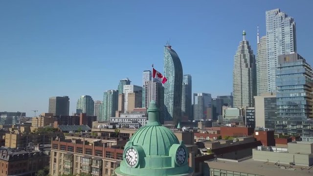 flying clockwise around Canadian flag with Toronto skyline in BG