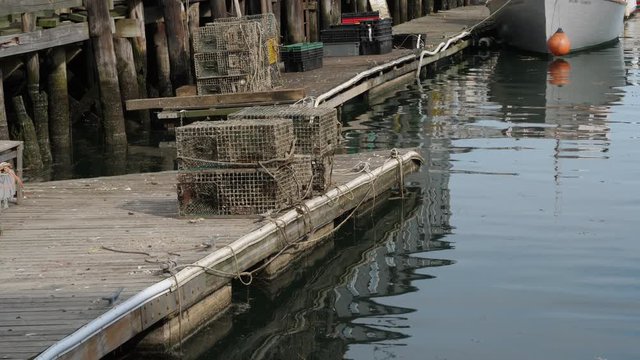 A day view of empty lobster cages on a pier in Portland, Maine.  	