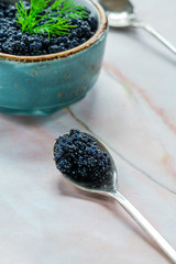 Black lumpfish caviar in a spoon