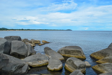 A rocky coastline against a blue sky, Lake Malawi