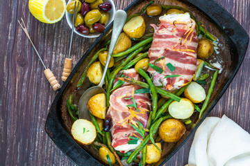 Bacon-wrapped haddock stuffed with crayfish tails, with lemony new potatoes, green beans and olives...
