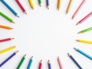 Color pencils on white paper background with oval shape. Education & Back to school Concept.