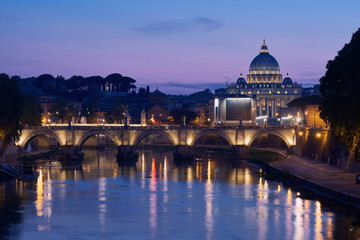 The blue hour view on gorgeous St. Peter's Basilica in the Vatican across the Tiber River in Rome,...