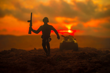 War Concept. Military silhouettes fighting scene on war fog sky background, World War Soldiers Silhouettes Below Cloudy Skyline at sunset. Attack scene. Armored vehicles. German tank in action