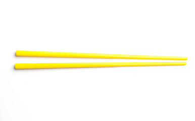Yellow chopsticks isolated on white