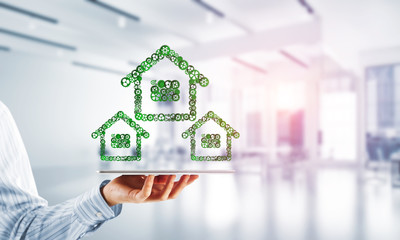 Real estate or construction idea presented by home icon on tablet pc