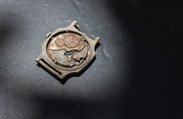 Old rusty watches (clockwork) on black
