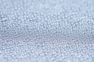 Brushed metal surface with water drops