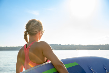 young sexy woman girl family are doing yoga on an sup board at a lake sea water