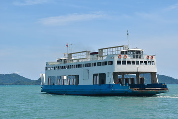 Large ferryboats carrying passengers and cars crossing in blue sea between Koh Chang island and Trad province, Thailand cargo logistics transportation delivery concept.
